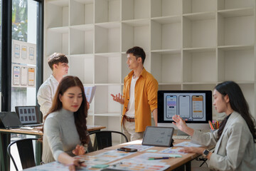 Ui ux designers collaborating on mobile app interface