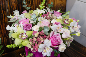 Luxury floral arrangement: pink roses, orchids, hydrangea in velvet box bouquet