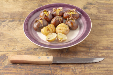 Roasted chestnut on a plate.Cleaned and in the shell.