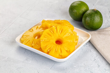 Sweet canned pineapple slices in syrope