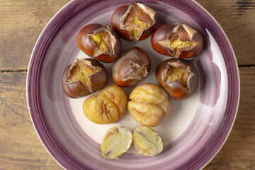 Roasted chestnut on a plate.Cleaned and in the shell.