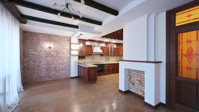 Spacious loft with exposed brick, dark wood beams, and a large kitchen. Features stained glass doors and a decorative fireplace