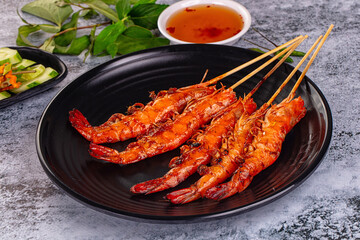 Grilled prawn skewer served sauce