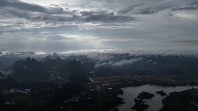 Cinematic Landscape: Golden Sunshower and Mist Over Mountain City, Aerial Drone Shot