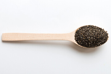 Wooden spoon and chia seeds on colored background, top view. Healthy Salvia hispanica Healthy superfood