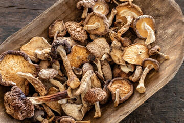 Dried shiitake mushrooms in the wooden bowl. 