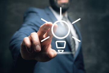 Businessman and light bulb on screen, concept idea