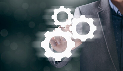 Businessman and blue gear icon on screen. Concept of the mechanism