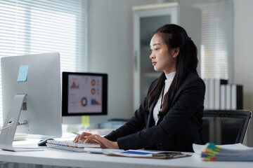 Asian businesswoman working on computer analyzing business data