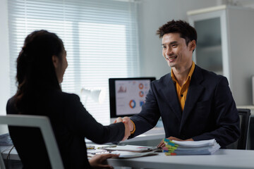Business people shaking hands in office meeting