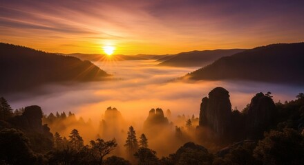 A vibrant sunrise casts golden light over majestic mountain peaks and a valley filled with mist