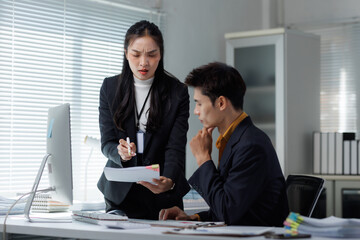 Woman discussing document problem with confused man