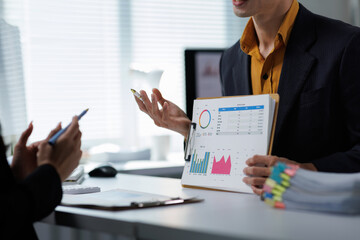 Business professionals discussing financial data presentation in office