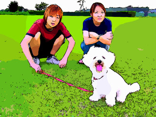 公園を散歩するビションフリーゼと男女