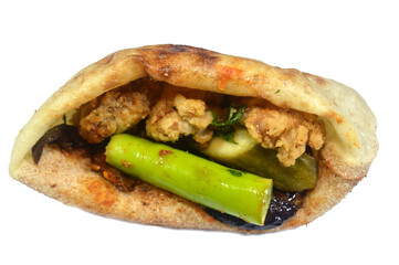 Cow beef brain covered with flour and fried in deep hot oil with green pepper, pickled eggplant and cucumber, a sandwich of fried brain in a traditional Egyptian flat bread with wheat bran