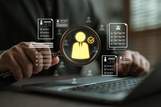 Businessman using magnifying glass to analyze resumes and select qualified candidates on a virtual interface, representing modern recruitment, HR analytics, and digital hiring process.