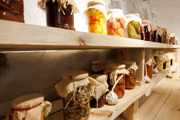 wooden shelf with jars of vegetables