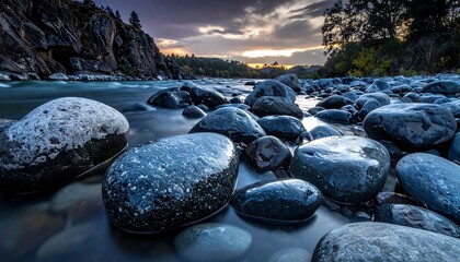 Serene Flow of River Water Over Smooth Stones at Dusk