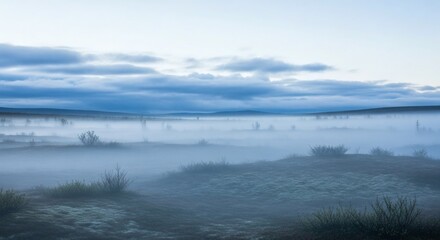 Misty landscape, low-lying fog over a plain, with a moody sky, at dawn or dusk
