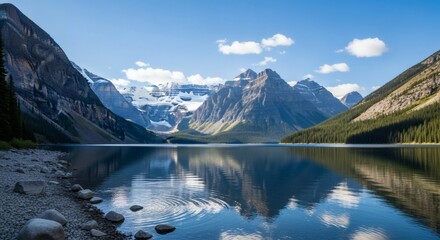 Scenic mountain lake with clear water reflecting peaks, under a bright blue sky