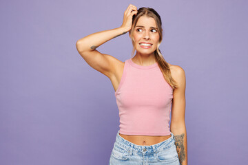 Young sad shocked mad mistaken woman she wearing pink tank top casual clothes put hand on head...