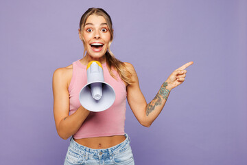 Young woman wears pink tank top casual clothes hold in hand megaphone scream announces discounts...