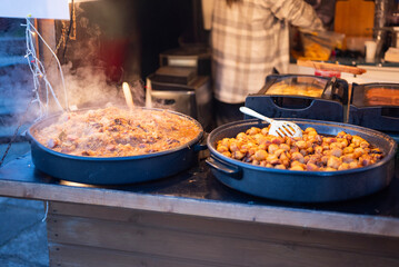 Prepared street food at a Christmas market, potatoes and cabbage, bigos, a national Polish food.