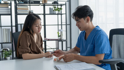 Dentist Examining Healthy Tooth Model While Consulting Patient