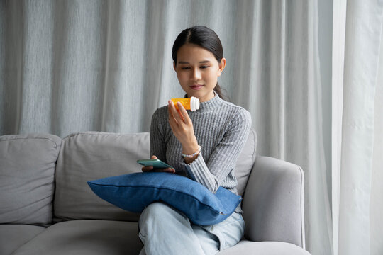 Asian Girl reading information online on mobile phone&nbsp;medicine