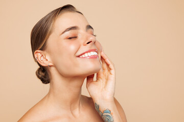 Close up beautiful half naked topless young woman 20s with nude make up close eyes touch face chin...