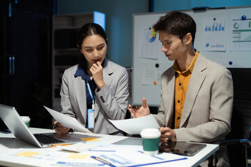 Business team analyzing financial data and planning projects in modern office.