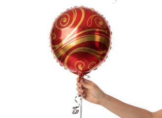 Person hand holding red gold balloon with warm celebration