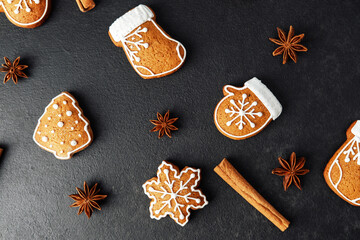 Christmas gingerbread cookies assortment arranged with star anise and cinnamon sticks on dark surface