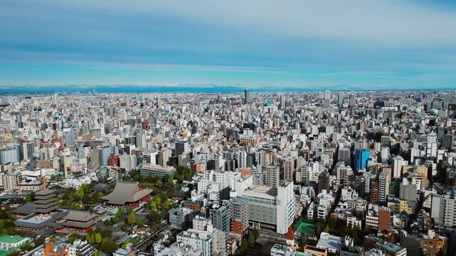 Slow forward drone shot reveals Asakusa temple in balance with modern Tokyo city