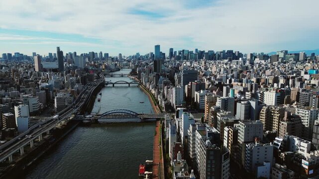 Static aerial shot shows Sumida River bridges cutting through modern Tokyo city