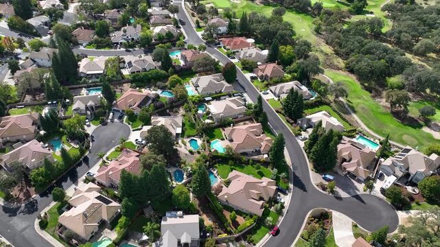Aerial view rotating over neighborhood homes in sunny Roseville, Northern California