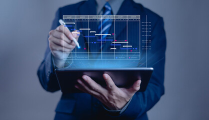 Businessman using tablet with virtual Gantt chart for project management, scheduling, and planning. Concept of digital data analytics, business process optimization, and modern technology strategy.