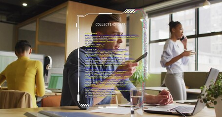 Collecting data adult male holding smartphone at open-plan office, with code overlay graphic