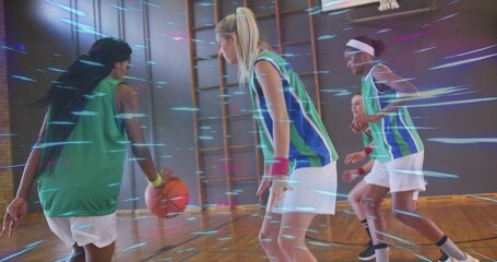 Dribbling basketball player in green uniform across school gym with orange basketball, copy space