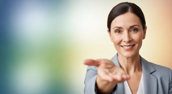 Confident woman businessperson offering hand on colorful background. Professional adult female leader reaching out with open palm.