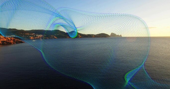 Fototapeta Flowing digital mesh wave overlay sweeping across seaside at sunset with rocky coastline and hills