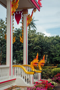 Temple entrance with golden Naga serpent statues, Wat Chalong, Phuket