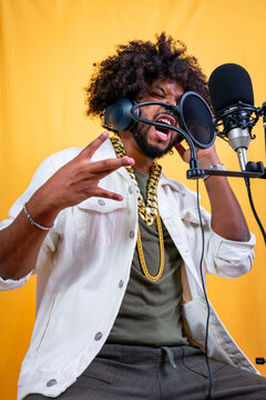 Black man rapping in recording studio with microphone