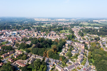 Aerial drone photo of the village of Ripon in North Yorkshire in the UK showing the historic British village and streets full of rows of terrace houses in the summer time