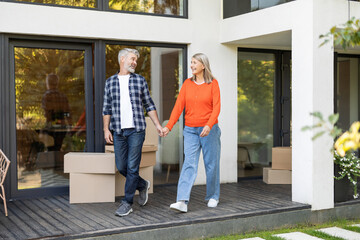 Mature couple walking hand in hand and looking happy