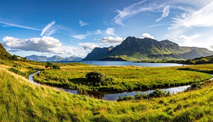 Obraz premium Scenic Coastal Landscape With Green Grassy Field Blue Water Body And Majestic Mountains Under A Bright Sunny Sky With Fluffy Clouds