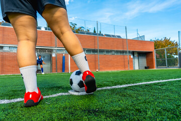 Woman soccer player kicking penalty shot during match