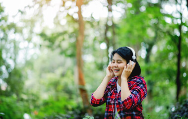 Fototapeta premium Listening to music with headphones and enjoying nature and relaxing with myself.