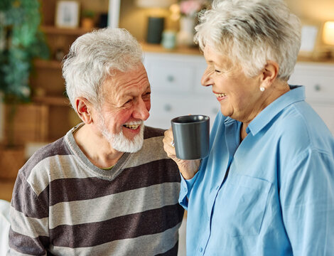 Happy active senior couple, portrait of an elderly woman with her husband sitting at home