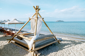 Empty deck chairs and beach umbrella on a sunny beach 